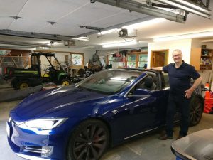 Richard Tubb with a Tesla